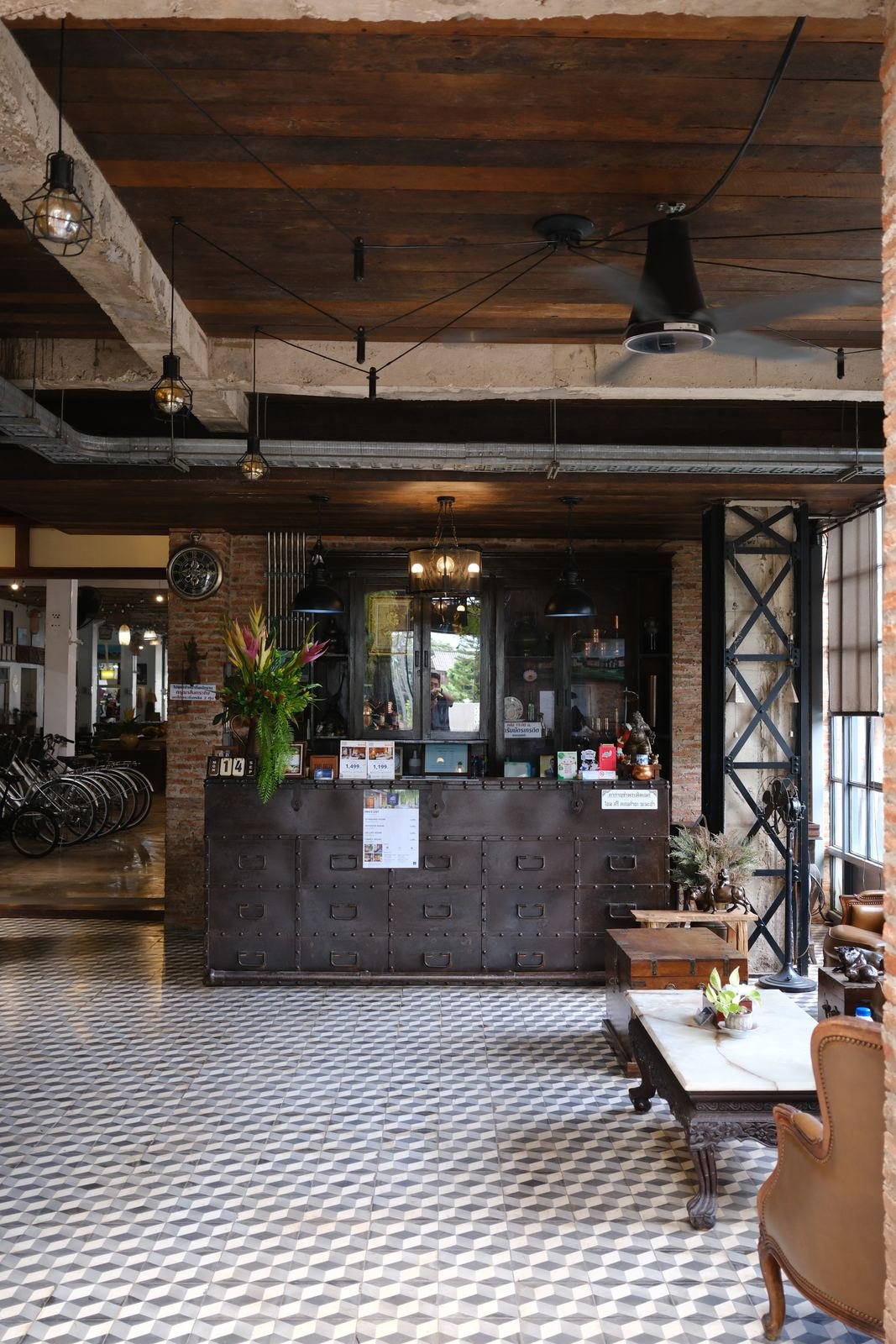 Reception desk on a black and white cement-tile floor