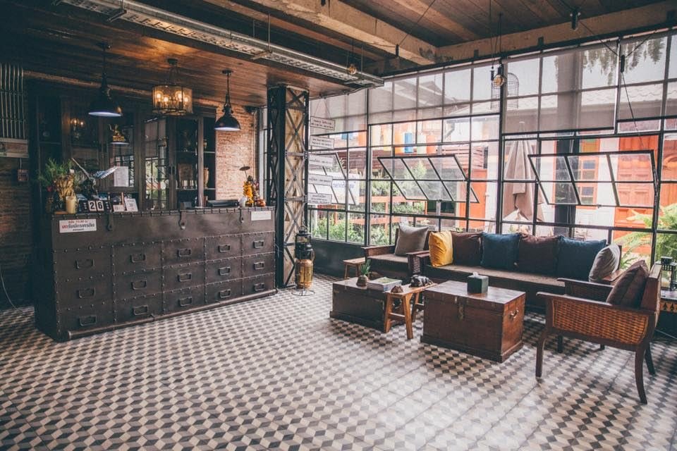 Lobby with apothecary-drawer reception, sofas and glass wall